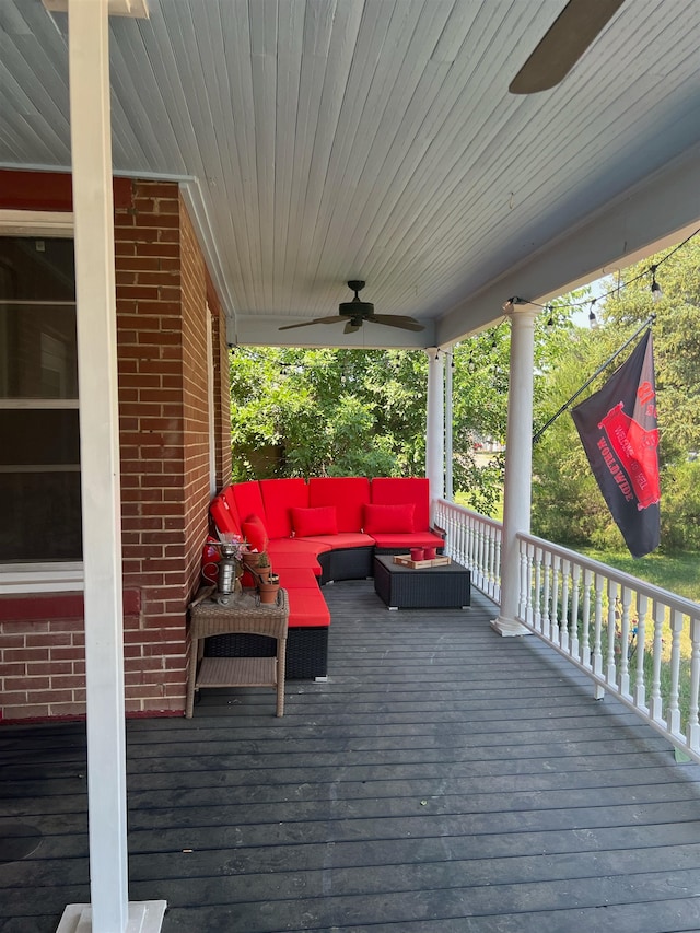 wooden deck featuring outdoor lounge area and ceiling fan