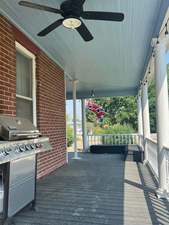 wooden terrace featuring a grill and ceiling fan