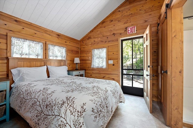 bedroom featuring light tile patterned flooring, lofted ceiling, and access to exterior