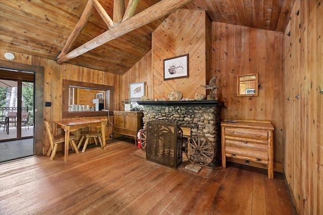 living room with wood walls, wooden ceiling, a fireplace, and wood-type flooring