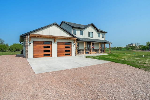 view of front facade with a porch, a garage, and a front lawn