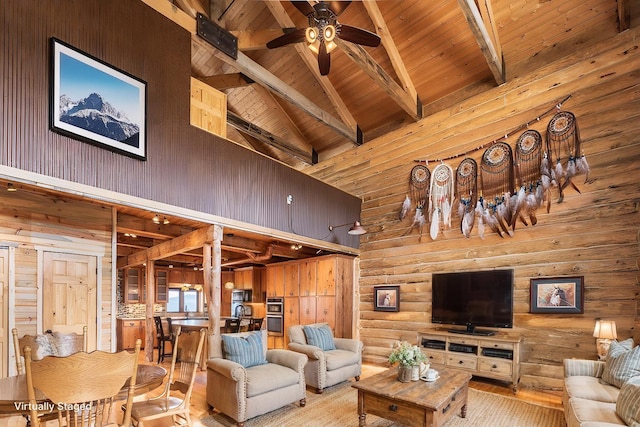 23470 Mineral Ln, Hill City, SD 57745 - living room with high vaulted ceiling, wood walls, beamed ceiling, ceiling fan, and wood ceiling