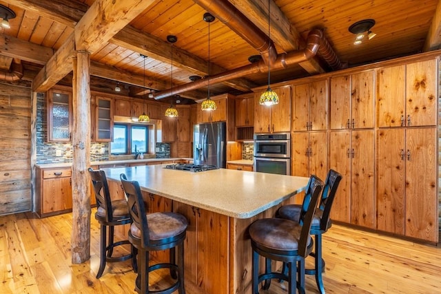 23470 Mineral Ln, Hill City, SD 57745 - kitchen with decorative light fixtures, wooden walls, wooden ceiling, and appliances with stainless steel finishes