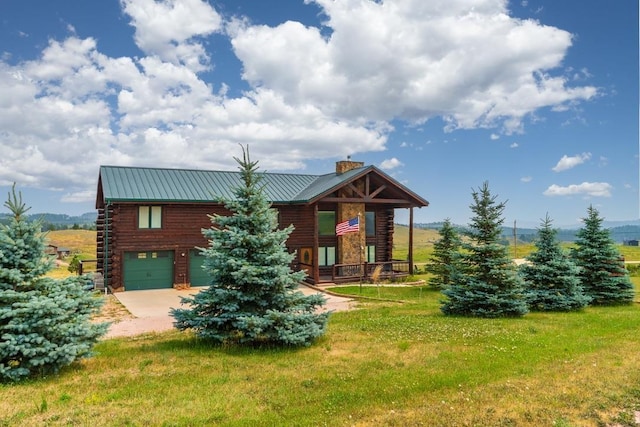 log cabin with a garage and a front yard