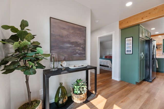 hallway with light hardwood / wood-style floors