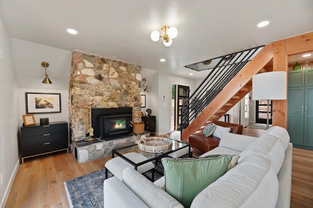 living room with a fireplace and light wood-type flooring