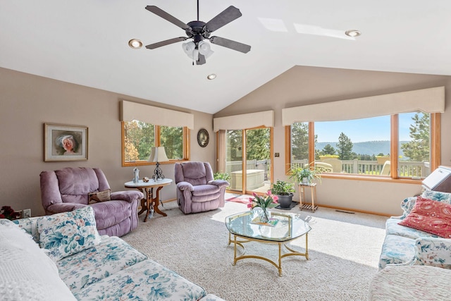 living room with lofted ceiling, light carpet, and ceiling fan