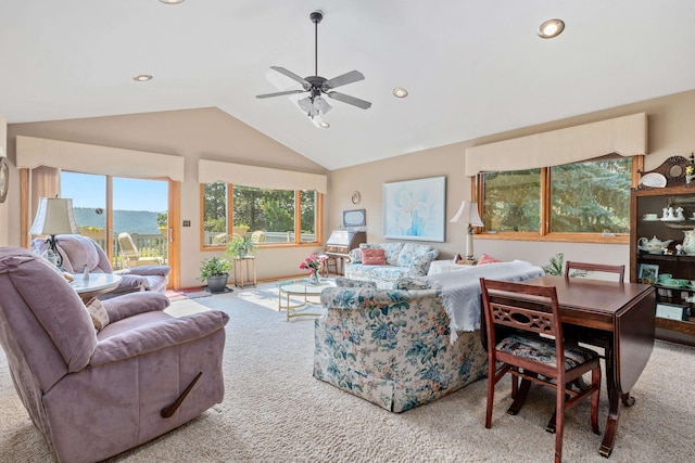 carpeted living room featuring vaulted ceiling and ceiling fan