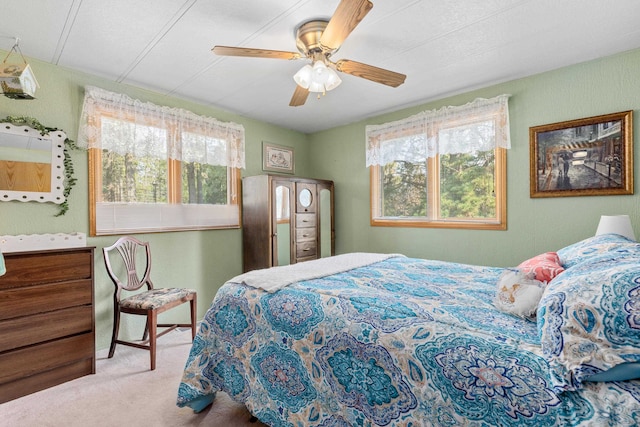 bedroom with light carpet and ceiling fan