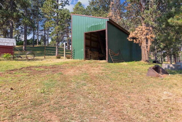 view of outbuilding featuring a lawn