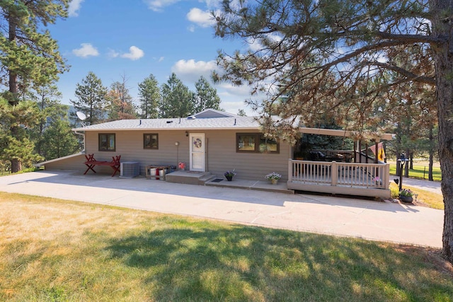 rear view of property with a yard and cooling unit