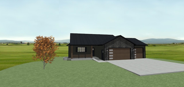 view of front facade with a mountain view, a garage, and a front yard