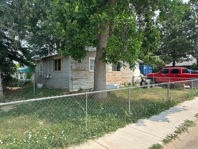 view of side of home featuring a lawn