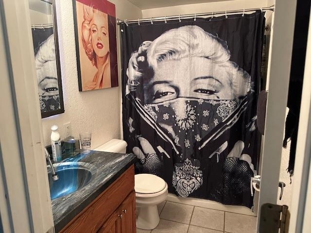 bathroom with vanity, toilet, and tile patterned flooring