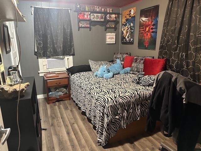 bedroom featuring hardwood / wood-style flooring and cooling unit