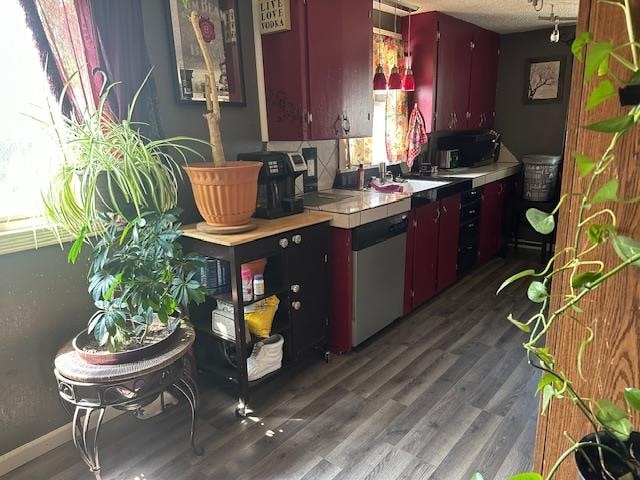 kitchen with dishwasher, decorative backsplash, and hardwood / wood-style floors