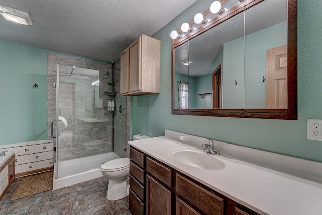 bathroom featuring vanity, an enclosed shower, a textured ceiling, and toilet