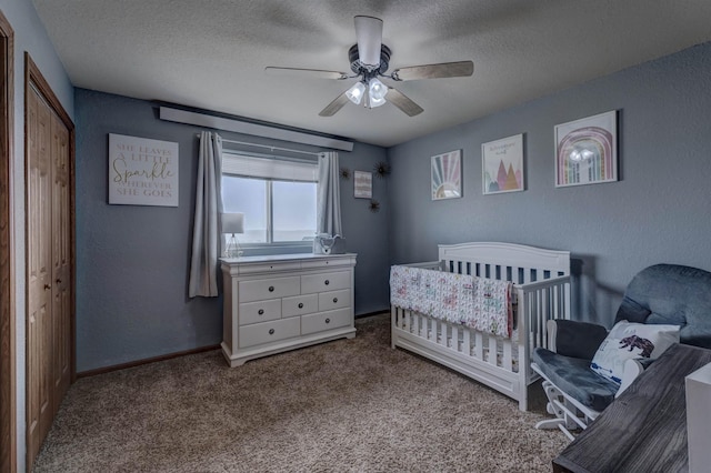 carpeted bedroom with ceiling fan and a textured ceiling