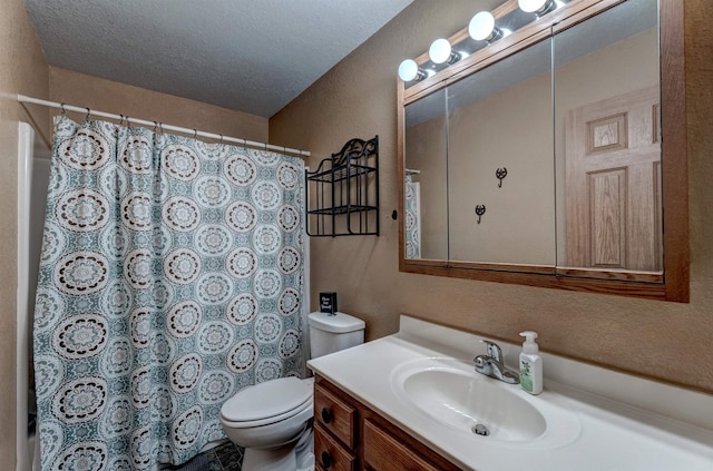 bathroom featuring vanity, a textured ceiling, and toilet