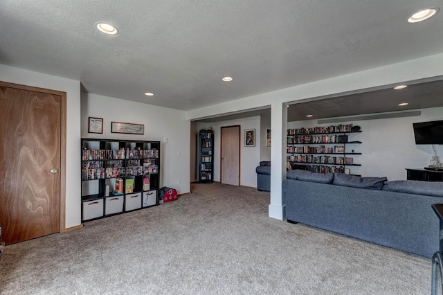 carpeted living room with a textured ceiling