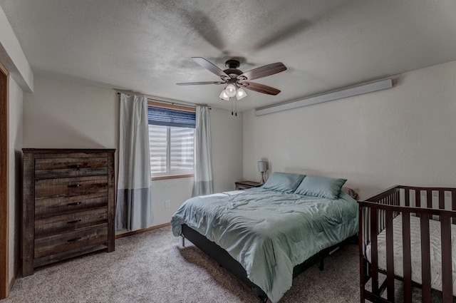 bedroom featuring ceiling fan, carpet, and a textured ceiling