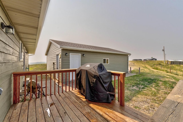 wooden terrace with a grill