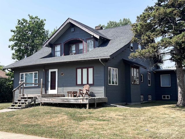 view of front of property with a wooden deck and a front yard