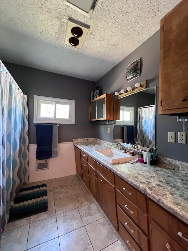 bathroom featuring vanity, a textured ceiling, and tile patterned floors