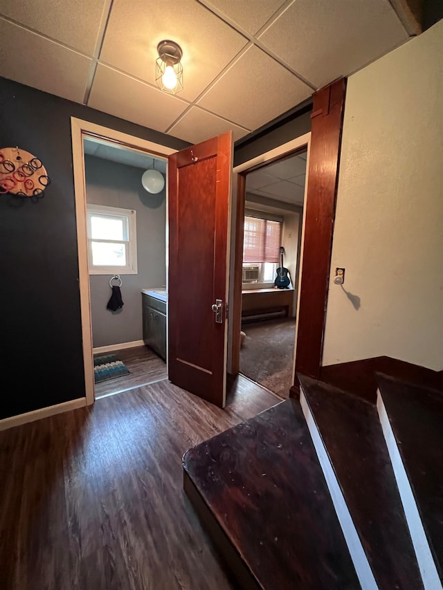 interior space featuring dark hardwood / wood-style floors and a paneled ceiling