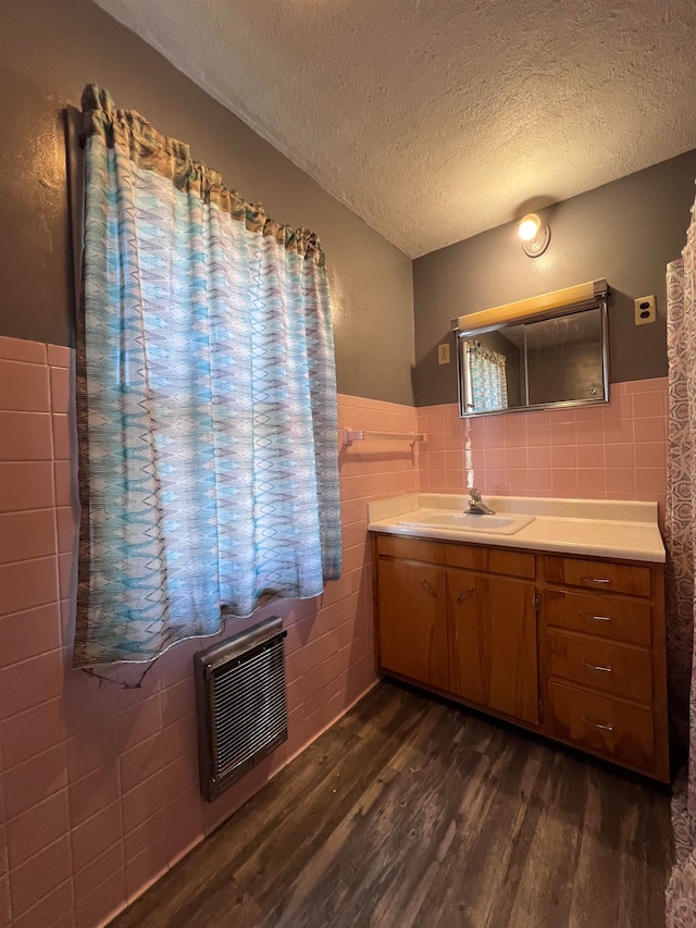 bathroom featuring vanity, decorative backsplash, tile walls, and hardwood / wood-style floors