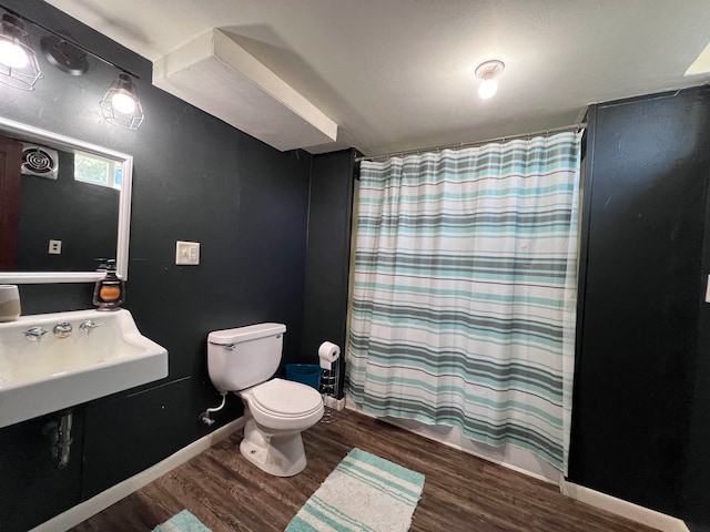 bathroom with sink, toilet, and hardwood / wood-style floors