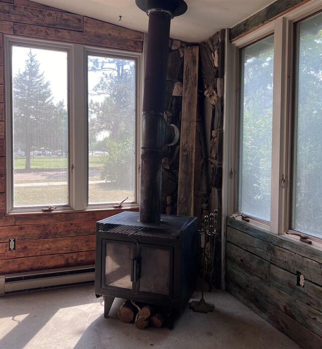 interior details with a wood stove and baseboard heating