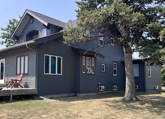 view of property exterior featuring a yard and a wooden deck