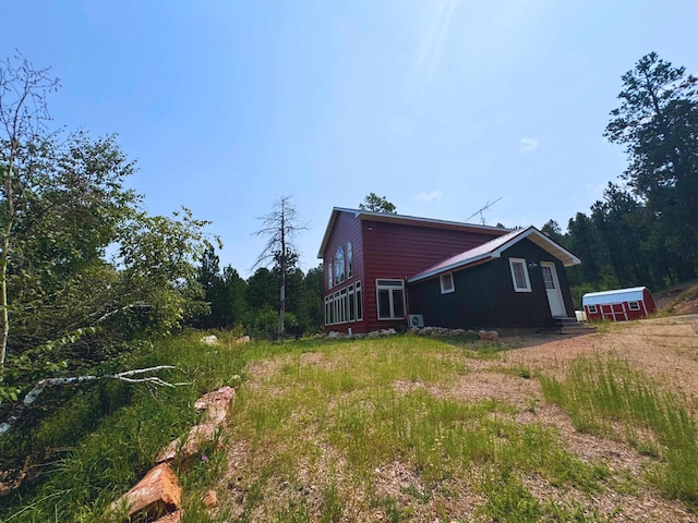 view of property exterior featuring an outdoor structure