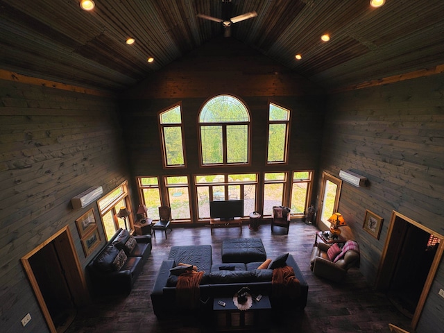 living room featuring wood ceiling, wooden walls, and high vaulted ceiling