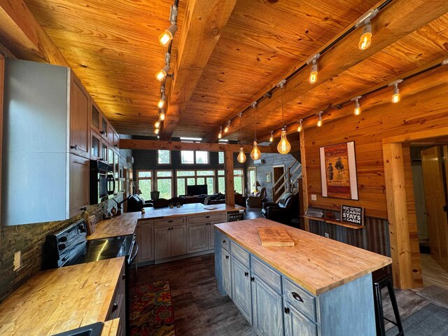 dining room with lofted ceiling, wood ceiling, light hardwood / wood-style floors, and wood walls