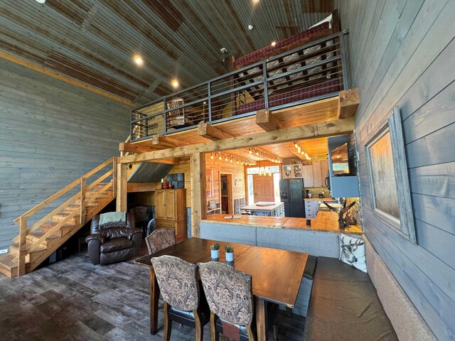 dining room featuring hardwood / wood-style flooring, vaulted ceiling, and wooden ceiling