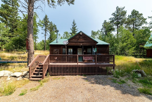 view of front of home with a deck and metal roof