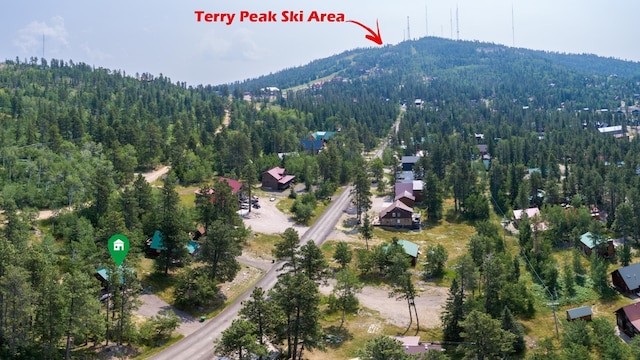 birds eye view of property with a view of trees