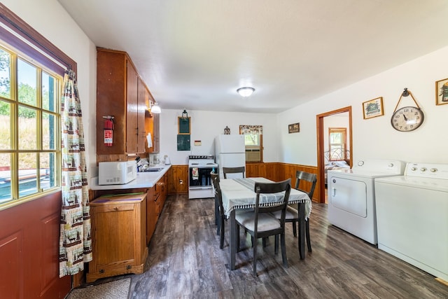 interior space featuring sink, washing machine and dryer, and dark wood-type flooring