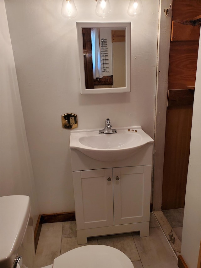 bathroom featuring tile patterned floors, vanity, and toilet