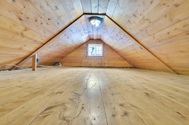 additional living space featuring wood ceiling, vaulted ceiling, wooden walls, and hardwood / wood-style floors