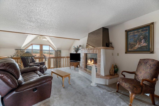 living room with carpet floors, a fireplace, a textured ceiling, and lofted ceiling