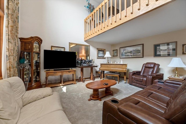 living room featuring carpet flooring and a high ceiling