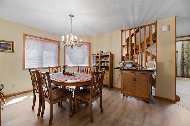 dining room with an inviting chandelier and hardwood / wood-style flooring