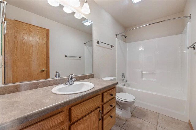 full bathroom featuring tile patterned floors, toilet, shower / washtub combination, and vanity