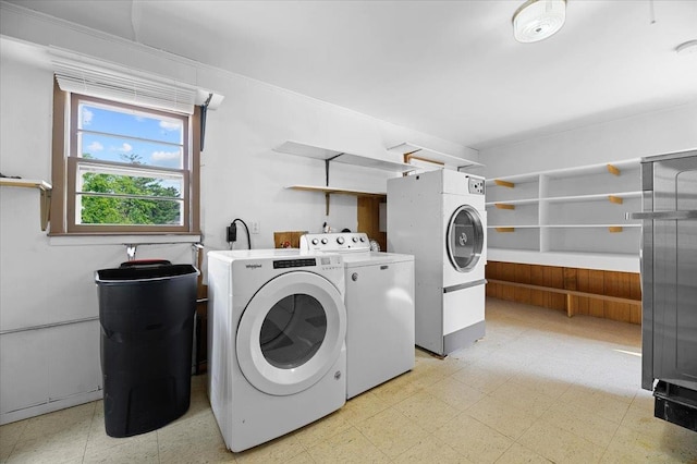 clothes washing area featuring light tile patterned flooring and independent washer and dryer