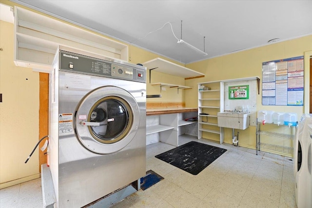 laundry room featuring tile patterned floors and sink