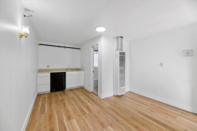 230 N Main St, Spearfish, SD 57783 - indoor wet bar with a heating unit, baseboards, and light wood-type flooring