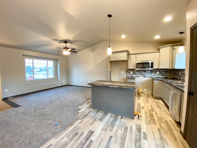 906 Top O Hill Ave, Hill City, SD 57745 - kitchen with ceiling fan, pendant lighting, decorative backsplash, light colored carpet, and lofted ceiling
